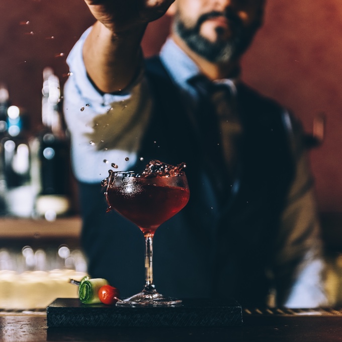 A photo of a bartender preparing a drink. The image represents the mixing traditional charm with modern amenities of Farnham.